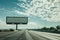 Blank billboard beside a sunny highway under a partly cloudy sky. Digital illustration.