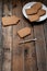 Blank biscuit gingerbread house, ready to decorate. Icing of Christmas bakery. Woman decorating honey gingerbread