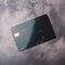 Blank black credit card with microchip on grey, copy space, created using generative ai technology