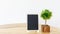 Blank black frame mock up picture frame  mini  tree in pot on wooden table