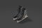 Blank black ice skates mockup pair, dark background