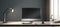 Blank black modern computer monitor with place for your web site or web design on sunlit wooden table with coffee cup, keyboard