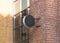 Blank black outdoor round box mockup brick wall mounted