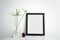 Blank Black Photo Frame and vase on table for Design Mockup