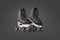 Blank black roller skates mockup pair on tiptoe, dark background