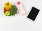 Blank black  screen computer tablet , vegetables and fruit in heart shape plate, bottle of water on white background with copy