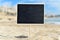 Blank black signboard on the beach