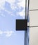 Blank black square sign on glas wall mockup, sky background