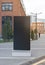 Blank black vertical pylon stand mockup brick building background