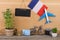 blank blackboard, flag of the France, airplane model, little bicycle and suitcase, camera, compass