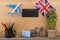 blank blackboard, flag of the United Kingdom, airplane model, little bicycle and suitcase, compass