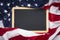 Blank blackboard over American flag as a concept for US national celebrations