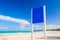 Blank blue billboard stands on an empty beach