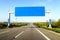 Blank blue freeway sign over the road on sunny day