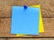 Blank blue memo card  on a wooden table. A blank space to enter a note or insert graphics