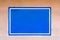 Blank Blue Sign on an Adobe Wall