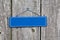 Blank blue sign on old rustic wooden fence