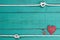 Blank blue sign with white rope border, red heart, bronze key and lock