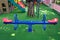 Blank blue teeterboard on the kids playground in garden