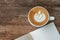 Blank booklet on wooden table with A cup of coffee