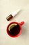 Blank bottle of nasal spray and cup of tea on light background