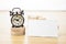 Blank Business card mock up and black alarm clock on light wooden table, Business corporate identity, Clipping path on business c