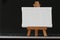 Blank canvas and wooden easel on laptop computer
