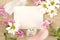 Blank card for easter greetings on wooden plank with eggs,flowers