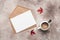 Blank card mockup, craft envelope, coffee cup and maple leaves on beige textured background. Autumn minamal scene. Female blogger