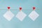 Blank cards on pins with red hearts. Mockup for text and blue background for Valentines Day greetings