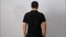 Blank collared shirt mock up template, rear back view, Asian male model wearing plain black t-shirt isolated on white. Polo tee