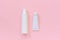 Blank cosmetic or medical white plastic bottle and tin tube for cream, shampoo, ointment, toothpaste or other product on pink