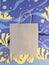 Blank craft paper bag on abstract sea underwater blue background. Matisse-inspired paper collage.