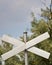 Blank crossing sign against trees and sky