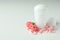 Blank deodorant and flower petals on white background