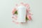 Blank deodorant and flower petals on white background