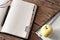 Blank diary on wooden table with apple closeup