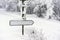 Blank direction sign in winter convered in snow