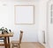 Blank framed print on white wall in danish styled interior dining room