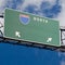 Blank freeway sign in blue cloudy sky