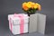 Blank gift card, bouquet of rose flowers and gift box over grey