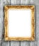 Blank golden frame on wood wall