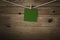 Blank Green Message Pegged to String against Wood Planks