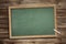 Blank green slate blackboard wooden background