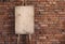 Blank grunge easel on a brick wall