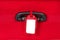 Blank identification tag over red suitcase