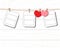 Blank instant photo and small red paper heart hanging on the clothesline