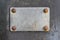 Blank metal plaque with rusty screws. Place for text.