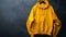 Blank mockup of a mustard yellow oversized hoodie with a front pocket and drawstring hood.