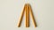 Blank mockup of a set of pencils arranged to form a triangle creating a visually dynamic display.